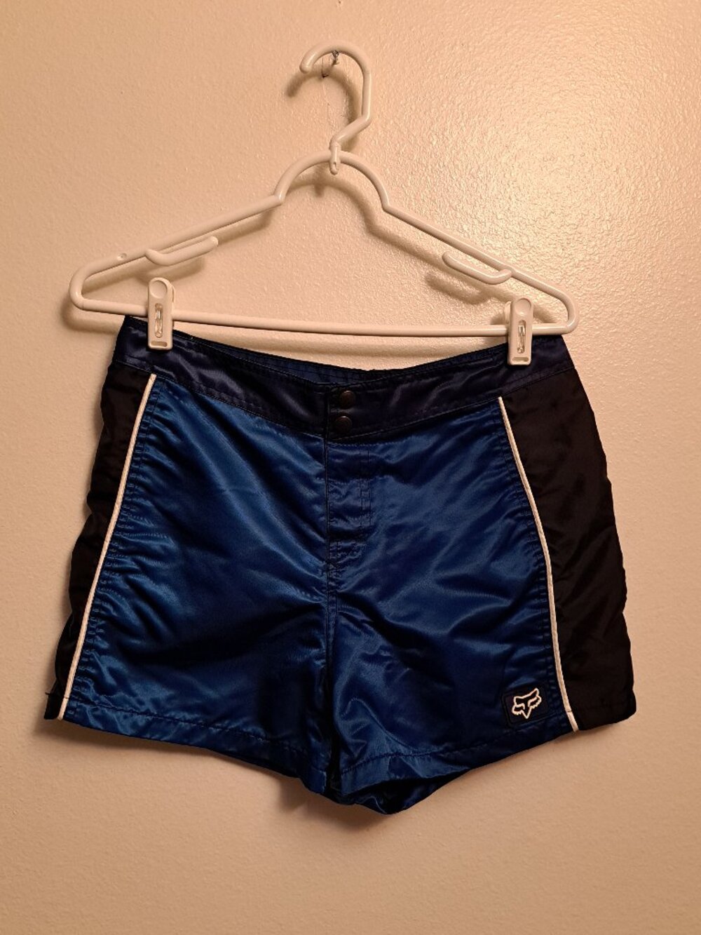 Vintage Fox Racing board shorts featuring a blue satin finish &white piping.